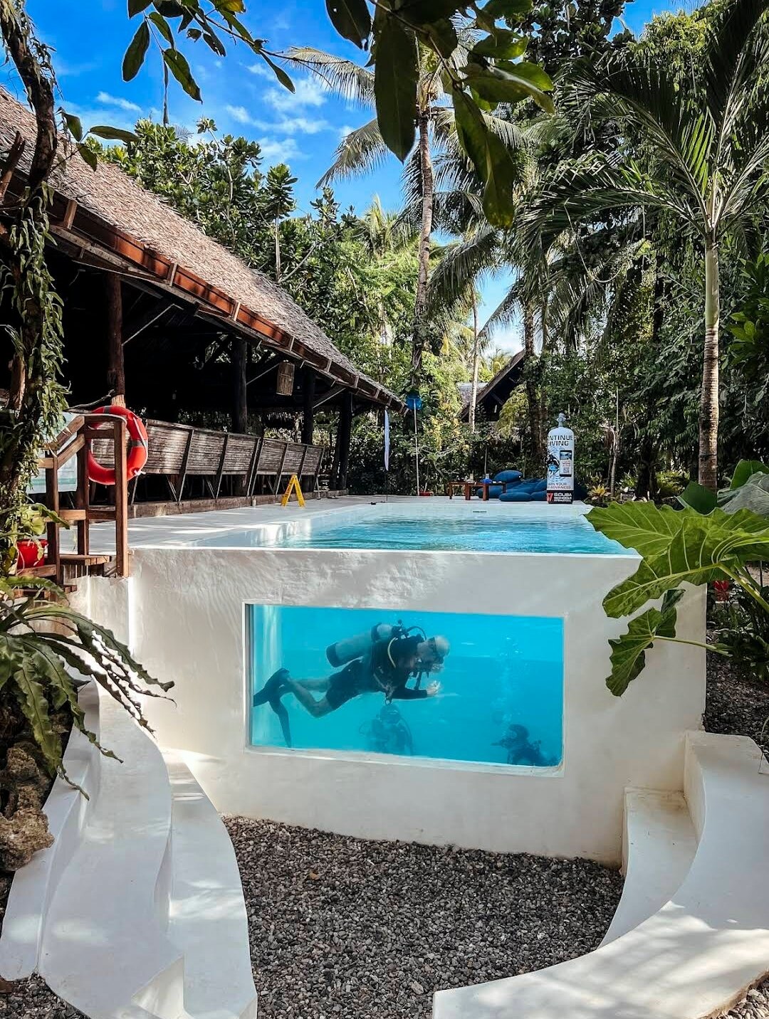 A student diver seen through the window of the dive center pool